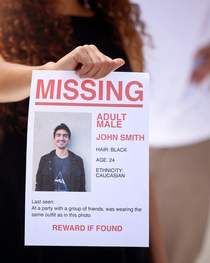 Bring back our loved ones. Shot of a woman holding a missing persons flyer.